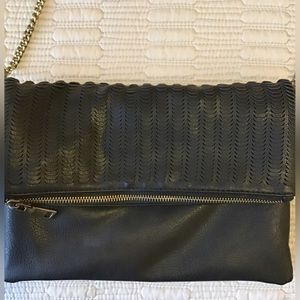 Black leather folded purse with brass colored chain.